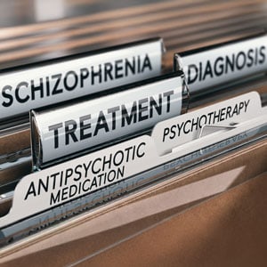 Close-up of medical files labeled with mental health-related terms like diagnosis, treatment, and medication